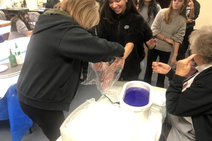 Students in cosmetology learn about the benefits of paraffin wax