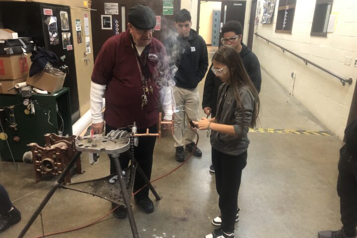 Students in Mr. Smith's Plumbing class apply their knowledge learned in the classroom and begin to work hands on by soldering pieces of pipe together.